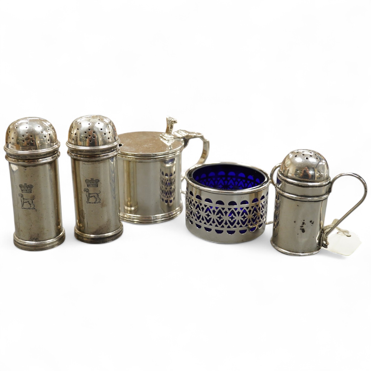 Five assorted silver condiments including a mustard pot and a pair of pepperettes, Birmingham, 1935, 79mm. Condition - fair